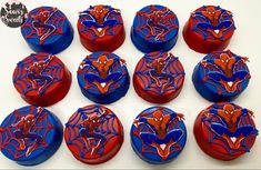 red, white and blue buttons with spiderman faces on them are arranged in a pattern