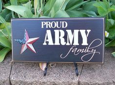 a wooden sign that says proud army family with an american star on the front and side