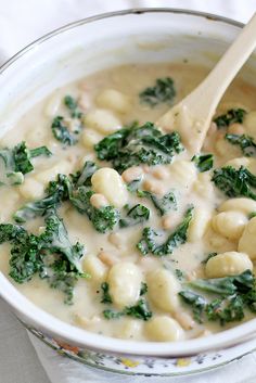 a white bowl filled with broccoli and macaroni in a cream sauce