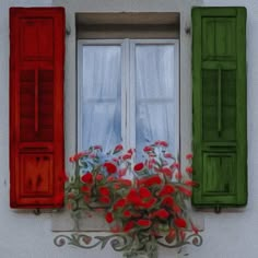 two windows with green shutters and red flowers