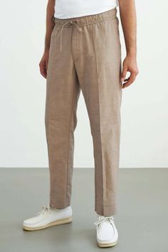 Eco-friendly Portuguese linen trousers that can be worn as everyday or casual suit pants. Made from a blend of 55% organic cotton and 45% linen, these comfortable trousers feature a relaxed drawstring waistband, two side pockets, and a hidden closure back pocket to maintain its shape. The straight cut with a wide leg ensures a stylish and versatile look. Pre-washed to prevent shrinkage, these trousers are ethically made in Lithuania and come with a repair guarantee. We discovered this high-quality fabric in Portugal and chose it for its special surface and breathable properties. A durable blend of easy care organic cotton and cooling linen. A fabric that will age beautifully and stay with you for a long time. 55% cotton, 45% linen machine washable at 30°C Comfortable Trousers, Winter Trousers, Aging Beautifully, Casual Suit, Suit Pants, Linen Trousers, Drawstring Waistband, Lithuania, Mens Trousers