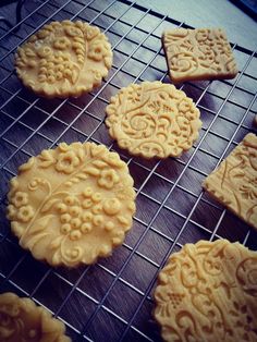 some cookies are cooling on a rack and ready to be baked in the oven,