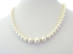 Beautiful beaded Wedding Necklace made of Swarovski Pearls. It is made of one strand of small pearls that get bigger in size at the front and is separated by silver spacers with clear crystals. It's a very romantic necklace that can be used for any bridal gown. The necklace measures approx. 18 inches, but can be made to your desired length (up to 22 inches). It ends with a small silver clasp.See last picture for matching earrings and bracelet available in my shop here: https://www.etsy.com/listi White Single Strand Necklace For Wedding, Adjustable Single Strand Pearl Necklace For Wedding, Adjustable Pearl Bridal Necklace For Wedding, Beaded Pearl Necklace For Anniversary, Single Strand Pearl Necklace For Wedding, Adjustable Classic Pearl Necklace For Wedding, Single Strand Pearl White Bridal Necklace, Pearl White Single Strand Bridal Necklace, White Single Strand Bridal Necklace With Round Beads