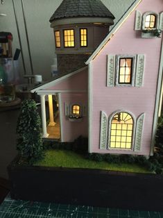 a pink doll house sitting on top of a table