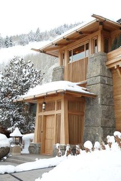 a wooden building sitting on top of a snow covered slope