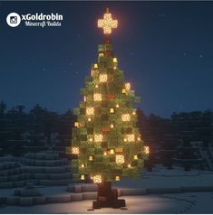 a lighted christmas tree in the middle of a snowy field