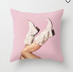 a pink pillow with an image of a woman's legs wearing high heeled shoes