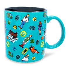 a blue coffee mug with stickers all over it