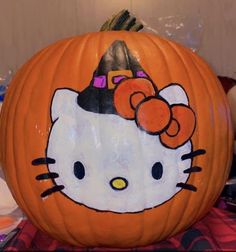 a hello kitty pumpkin with a bow on it