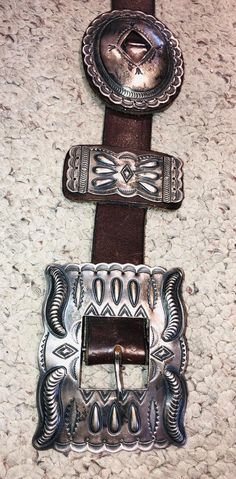 Exceptional old vintage classic Navajo concho belt from the early 70's with exquisite repousse/relief work, by Navajo jewelry artist Albert Payton... stamp signed "A Payton" & Sterling” on the buckle. Leather belt is 51 5/8” long x 1 1/4 “ wide. Each silver piece is mounted on leather.   Silver has patina.  303RPlease see our other Concho belts here:https://www.etsy.com/listing/681360149/concho-belt-turquoise-sterling-silver?ref=shop_home_active_3&frs=1***- This stunning item is coming f Southwestern Concho Belt For Western-themed Events, Silver Leather Concho Belt Buckles, Southwestern Concho Belt Buckles For Ranch, Traditional Concho Belt Buckles For Western-themed Events, Bohemian Concho Belt Buckles For Western-themed Events, Southwestern Antique Belt Buckle For Rodeo, Southwestern Hand-tooled Belt Buckle For Western-themed Events, Vintage Silver Hand Tooled Belt Buckles, Hand Tooled Silver Leather Belt Buckles