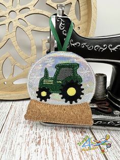 a glass ornament with a tractor on it