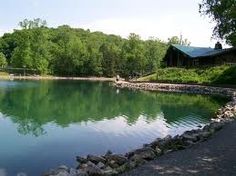 a lake surrounded by lots of trees and rocks