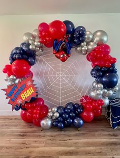 a spiderman balloon wreath with red, white and blue balloons in the shape of an octagon