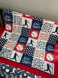 a baseball themed quilt on top of a crib