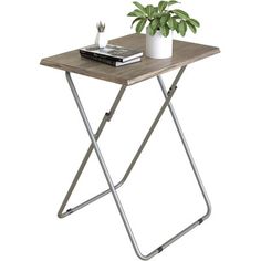 a small wooden table with metal legs and a potted plant sitting on top of it