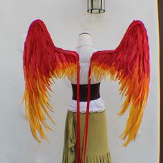 a mannequin with red, yellow and orange wings on it's back