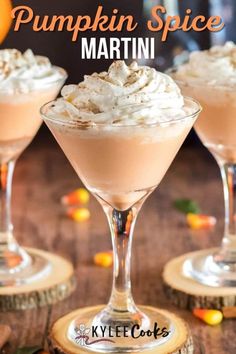 pumpkin spice martini with whipped cream and candy corn on the rim, served in coupe glasses