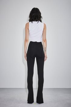 This melodic burst of creativity is channeled through exquisite fabrics and mesmerizing textures that stunningly grace each canvas. The Isaiah pants is knitted with our signature power stretch viscose. Its fit and flare silhouette is accompanied by pin tuck detailing at the front and back. Final touches include slit details at the ankle. Fashion Futurism, Hi Fashion, Tennis Fashion, Ponte Pants, How To Hem Pants, Futurism, Slim Pants, Pin Tucks, Work Outfits