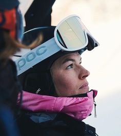 a woman wearing skis and goggles on top of her head