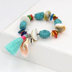 Brand New Stretchable Handmade Seashell Stone Bracelet. Detailed With Multiple Seashells And Silver Alloy Charms Throughout The Bracelet. Perfect For Your Summer Beach Day Beautiful Vibrant Colors B100 Adjustable Beaded Bracelets With Tassels For Beach, Blue Bohemian Strand Bracelet, Blue Bohemian Strand Bracelets, Blue Beachy Bracelet For Festivals, Adjustable Tassel Jewelry For The Beach, Adjustable Tassel Jewelry For Beach, Multicolor Casual Jewelry With Tassels, Handmade Dangle Bracelets For Beach, Turquoise Bohemian Beaded Bracelets For Beach Season