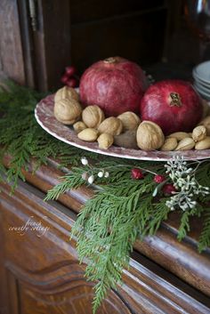 a plate with nuts and apples on it