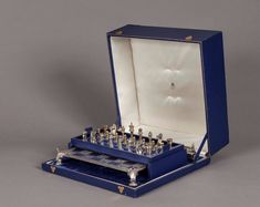 an open blue box with chess pieces in it