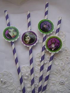 three purple and white striped straws with pictures on them