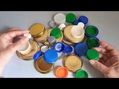 two hands are holding jars with lids on them and one hand is reaching for the lid