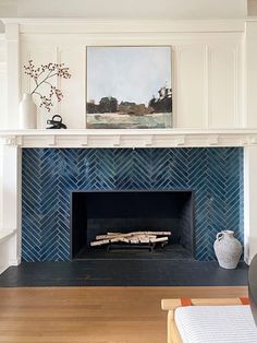 a living room with a fire place and blue tiles on the fireplace mantels