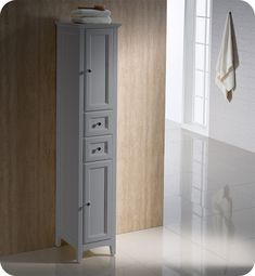 a tall white cabinet sitting in the corner of a room next to a toilet paper roll