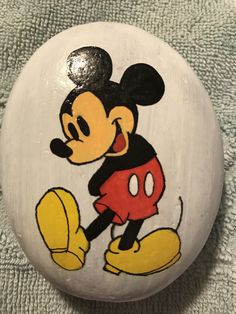 a mickey mouse painted on a white rock