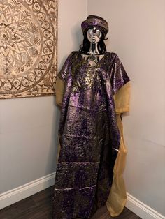 African/Nigeria bubu brocade outfit. One size. Oversized,And  Please note measurements: Width: 64inches Lenght: 62inches Long Purple Festive Kaftan, Festive Long Purple Kaftan, Bohemian Style Long Purple Thobe, Purple Bohemian Long Thobe, Long Purple Kaftan For Festival, Bohemian Style Long Agbada In Free Size, Purple Free Size Long Kaftan, Bohemian Gold Long Thobe, Gold Long Bohemian Thobe