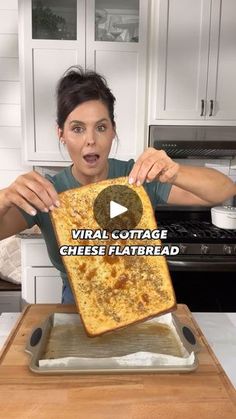 a woman holding up a piece of bread with the words virtual cottage cheese flatbread on it