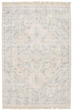 an antique rug with fringes on the edges and a medallion design in grey, beige and white