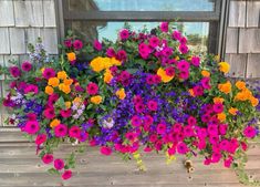 a window box filled with lots of colorful flowers