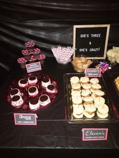 there are many desserts displayed on the table for people to eat at this party