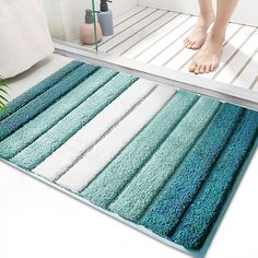 a blue and white bathroom rug on the floor