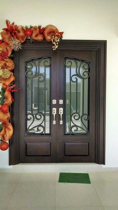 the front door is decorated with orange and gold decorations