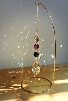 a glass bead hanging from a metal stand