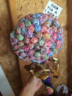 a person holding a bouquet of candy in their hand