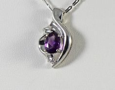 A lovely pendant with a deep purple amethyst and diamond accent in 14k white gold. The metal is 14k solid white gold Genuine Brazilian amethyst is an 8 x 6mm oval and weighs 1.15 carats The diamond is a round brilliant .01 carat G-H color VS2 clarity The total length of the pendant is 1 inch The chain is not included. Jewelry from Stowe Gems arrives beautifully packaged in a gift box. If you have any questions about this piece or if we can help you with any of our other products please feel free Silver Birthstone Necklace For Formal Occasions, Purple 14k White Gold Jewelry As Gift, Purple 14k White Gold Jewelry Gift, Purple Pendant Birthstone Necklace For Anniversary, Amethyst Pendant Birthstone Necklace For Anniversary, Anniversary Amethyst Gemstone Birthstone Necklace, Amethyst Gemstone Birthstone Necklace For Anniversary, Purple Birthstone Necklace For Anniversary, Silver Oval Birthstone Necklace For Anniversary