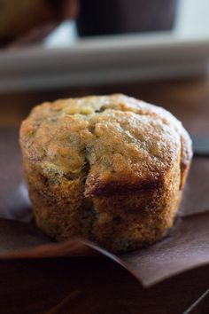 a muffin sitting on top of a piece of brown paper