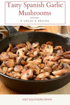 a pan filled with mushrooms on top of a wooden table