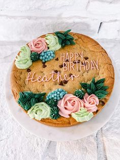 a birthday cake with frosting and flowers on it