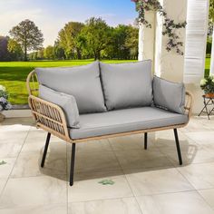 an outdoor sofa with grey cushions on a patio