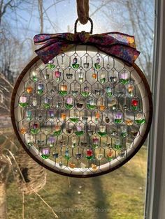 a stained glass sun catcher hanging from a window