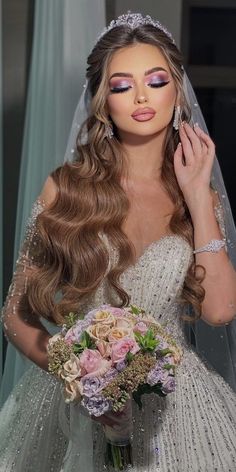 a woman in a wedding dress holding a bridal bouquet and looking at the camera