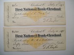 two checks from the first national bank cleveland and first national bank cleveland, both signed in gold