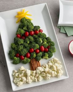 a christmas tree made out of broccoli and cauliflower on a plate