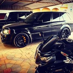 two vehicles parked in a garage next to each other